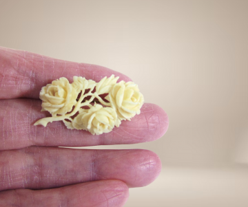 Antieke broche gesneden been roosjes beige achtergrond 3