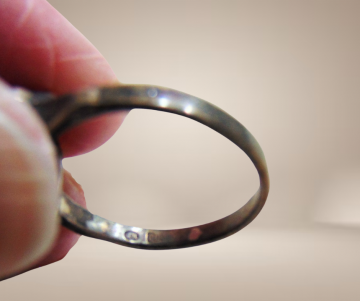 Antieke zilveren ring met patina rode glas steen breuk beige achtergrond 4