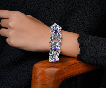 Art nouveau antiek zilveren amethist brede armband op arm hout stoel