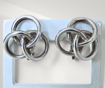 Gladde zware zilveren knoop oorbellen clips pr achtergrond 1