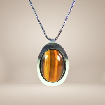 Grote teka theodor klotz modernist zilver tijgeroog hanger ketting beige achtergrond 1