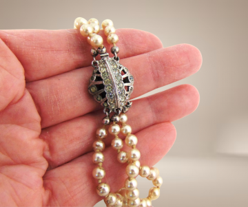 Grote zware 3 strengen glas parel collier strass beige achtergrond