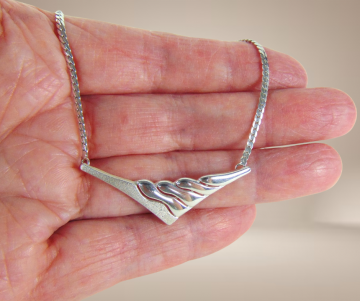 Modernist mat glans zilver v golf ketting beige achtergrond 4