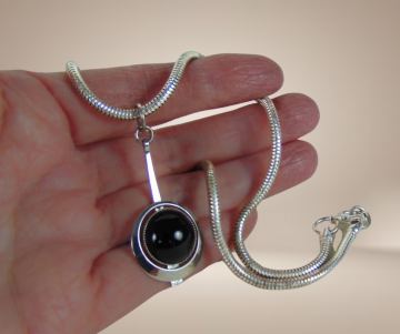 Modernist zilverkleur ketting hanger onyx beige achtergrond 4