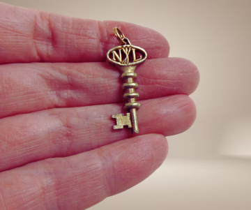 Vermeil zilveren sleutel hanger beige achtergrond 1