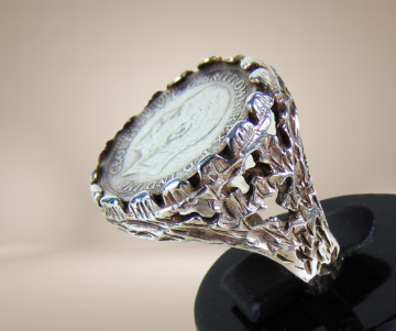 Zilveren engelse pence george v munt ring brutalist beige achtergrond 3