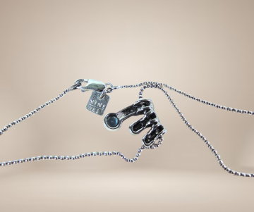 Zilveren nieuwe hanger zirkonia blauw accent nine west ketting beige achtergrond